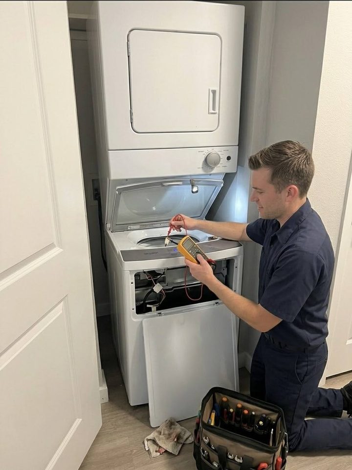 Anchor technician testing a stacked washer-dryer pair