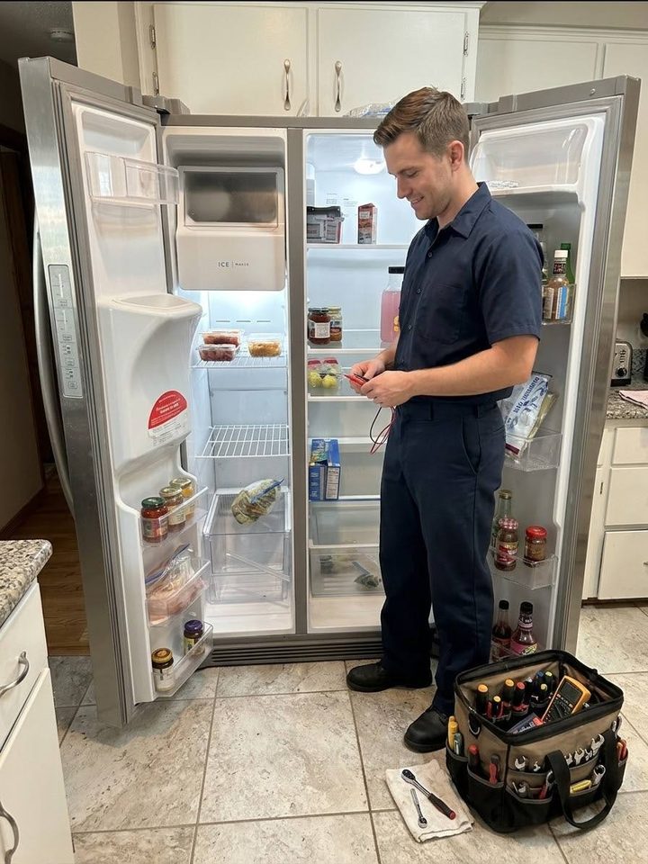 Anchor technician servicing a side-by-side refrigerator